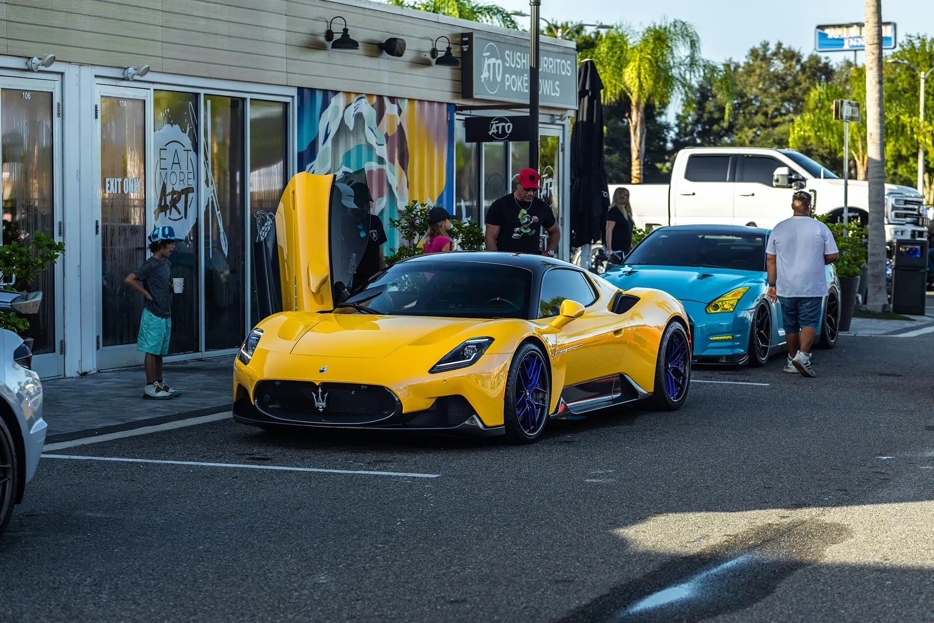 A Maserati parked on the street with the door open